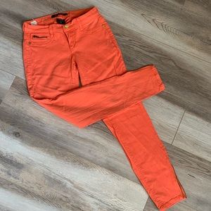 Salmon Peach colored skinny vintage jeans with gold hardware